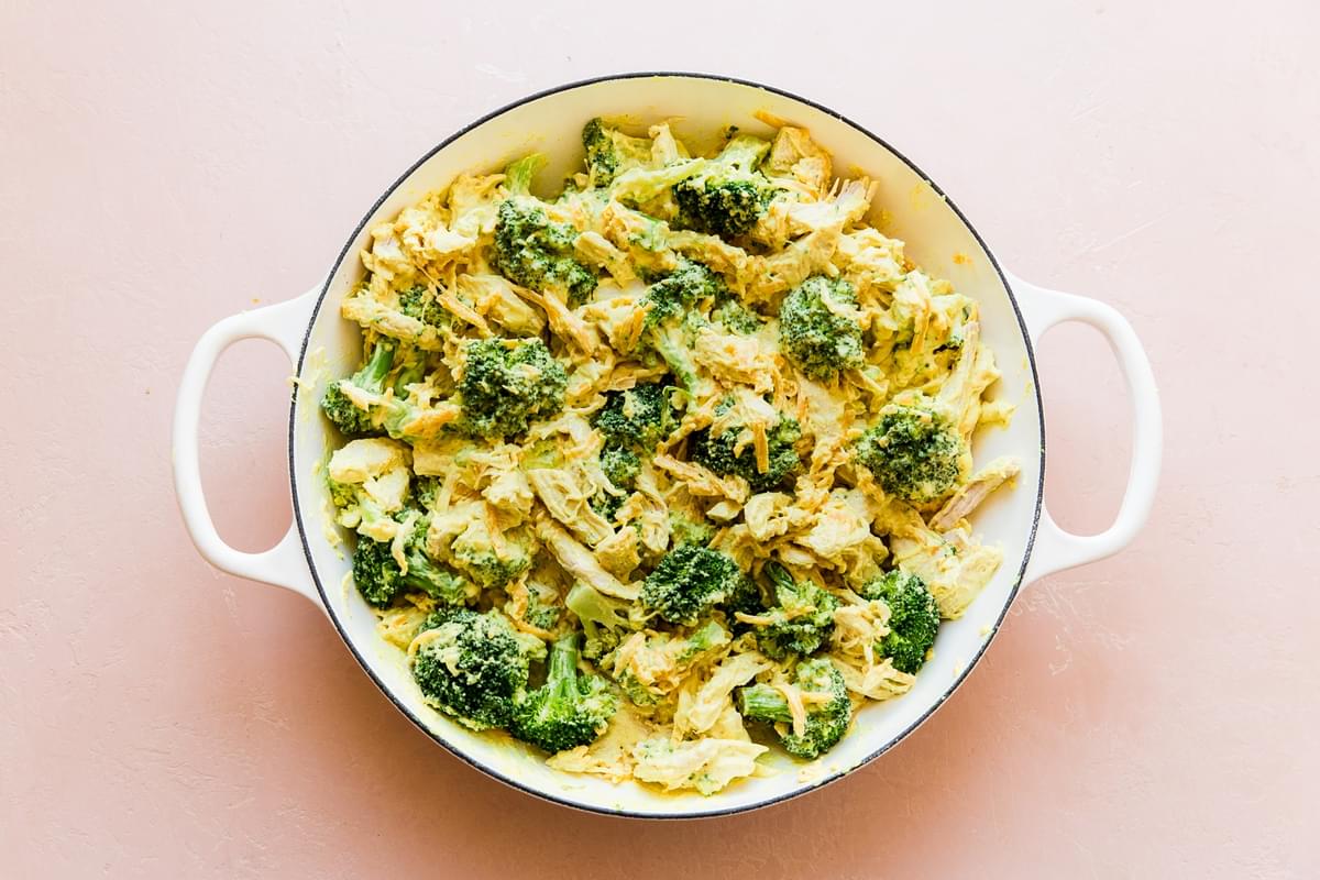 broccoli, shredded chicken, cheddar cheese, chicken divan in a pan