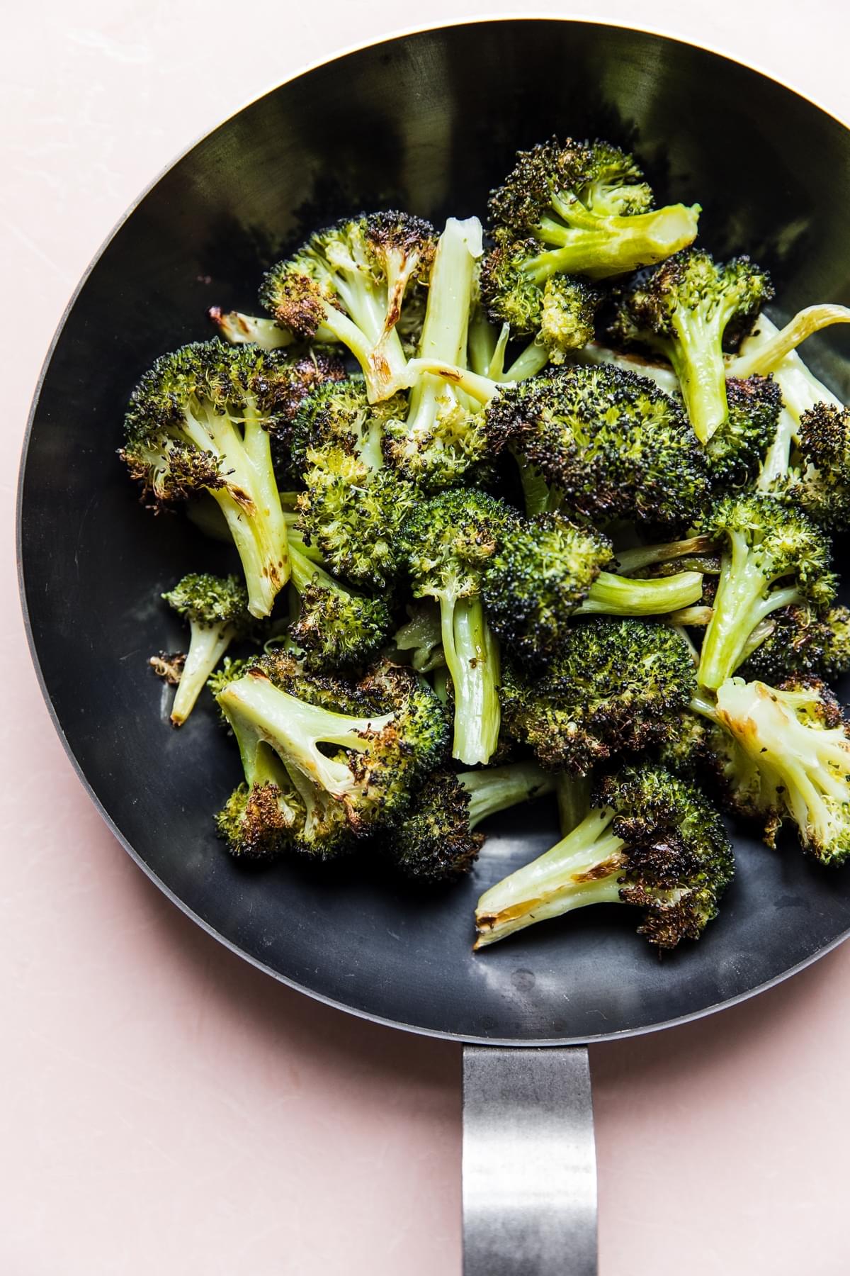 cooked broccoli crisping up in a skillet