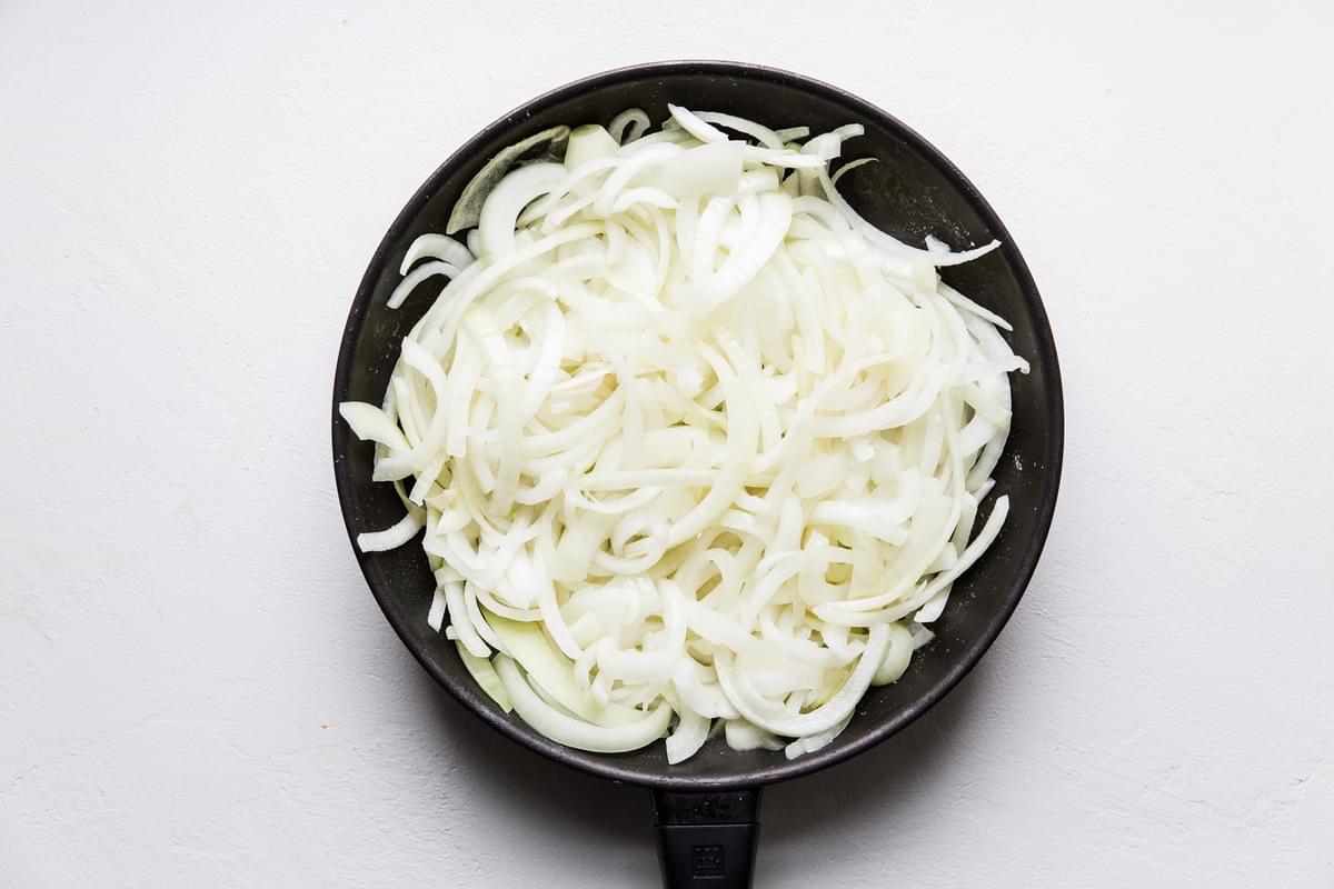 3 large yellow onions sliced in a pan with oil and butter