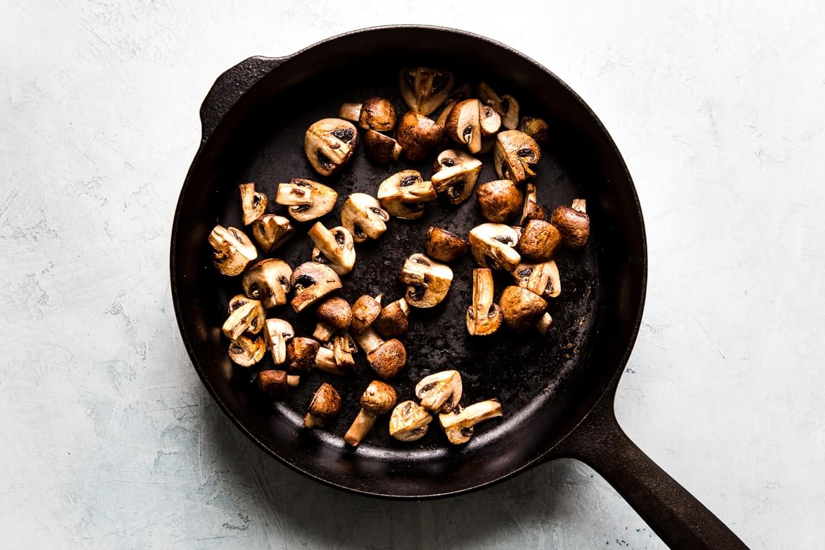 Mushrooms sautéing in a pan