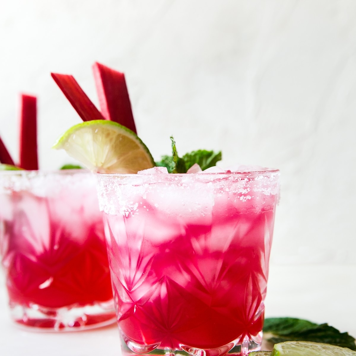 bright pink Rhubarb Mint Margarita with Jalapeño Tequila with lime