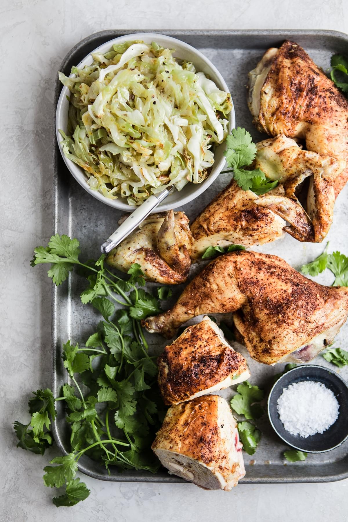 Low Carb whole roasted chicken dinner cut up and served with braised cabbage