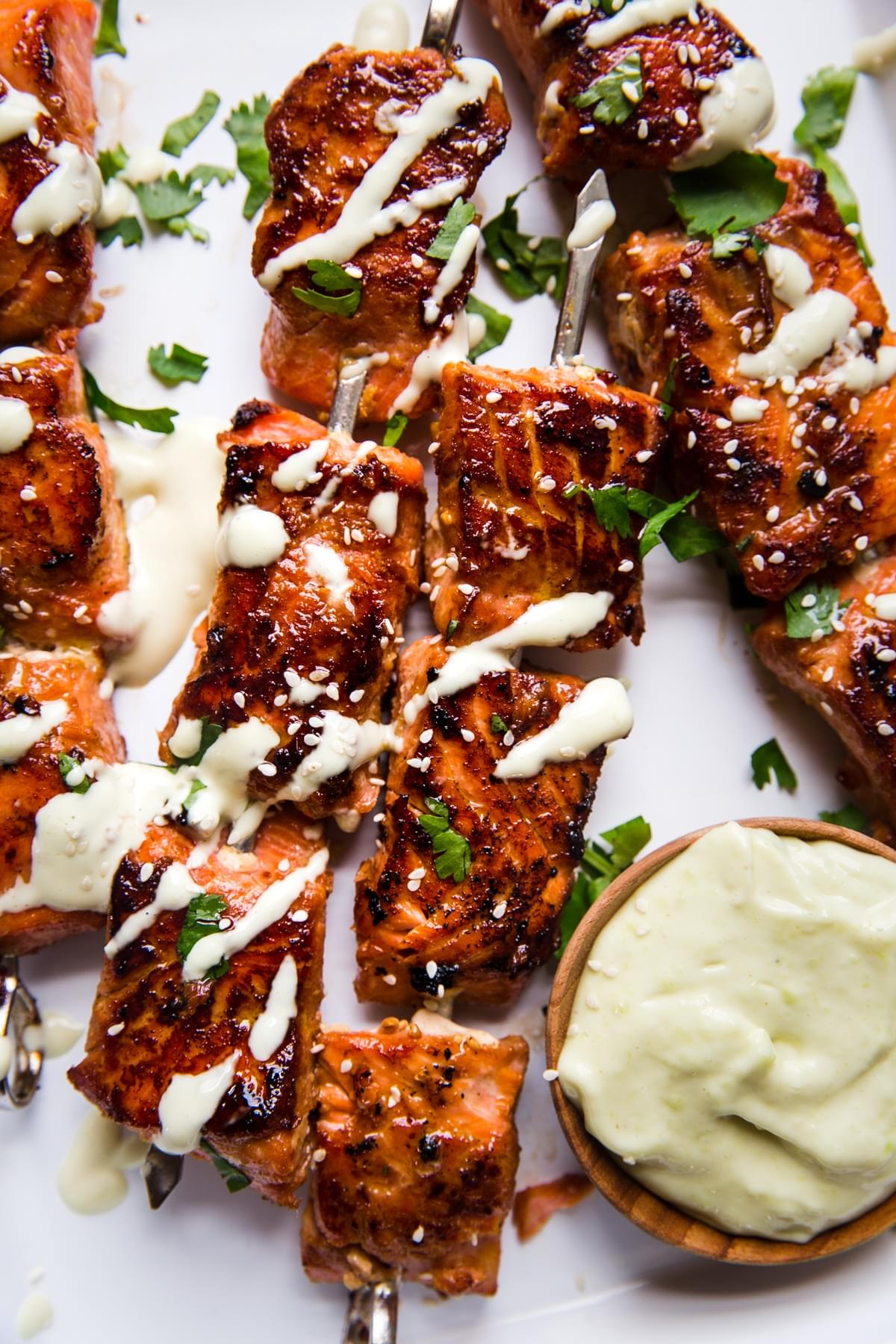 crispy salmon bites drizzled with wasabi mayo and topped with fresh cilantro