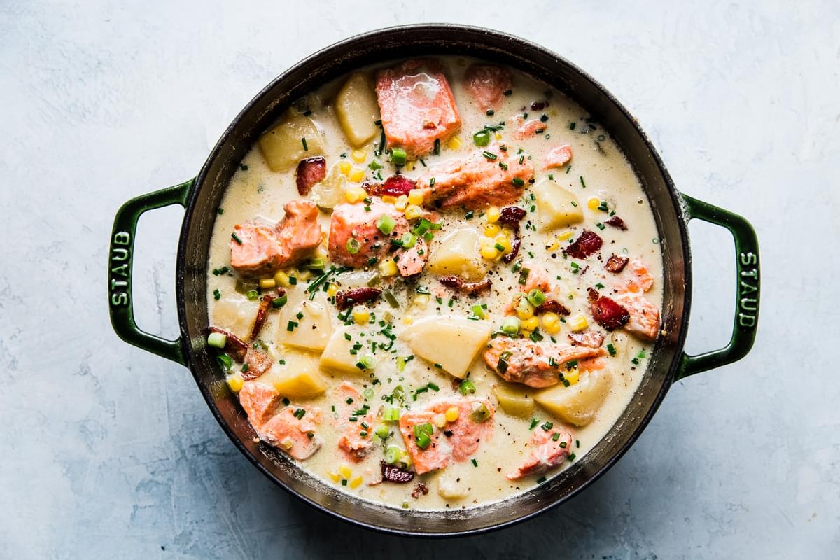pot of salmon chowder with bacon, onions and potatoes
