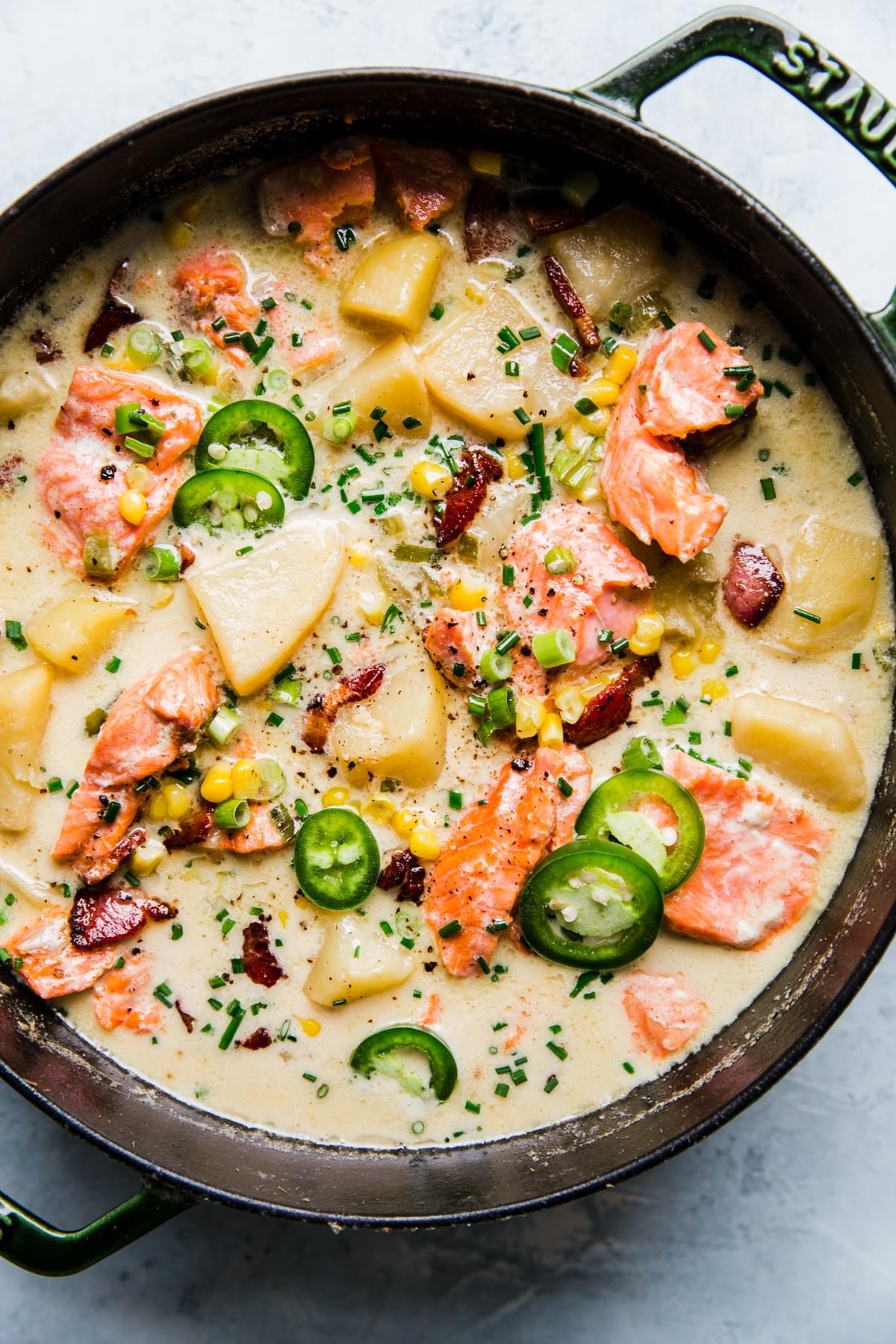 a large pot of salmon chowder with bacon, onions and potatoes