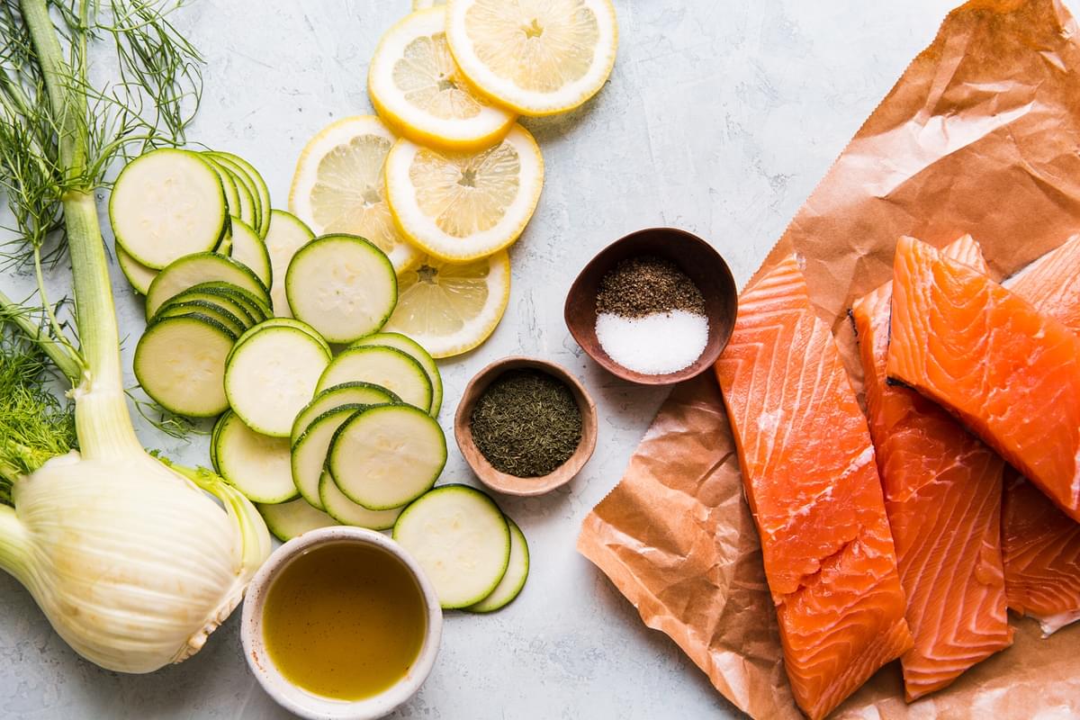 ingredients for salmon in parchment paper zucchini, lemon, olive oil