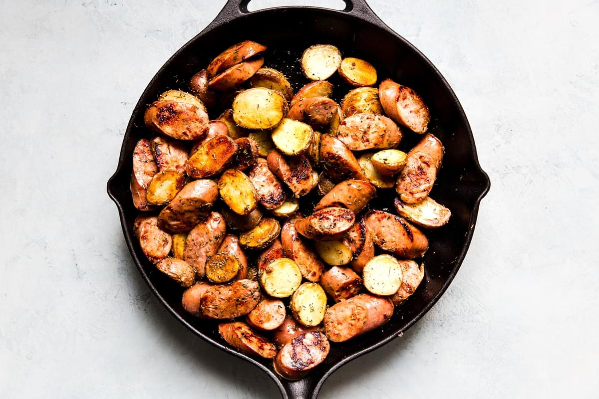 chicken sausage potatoes in a cast iron skillet