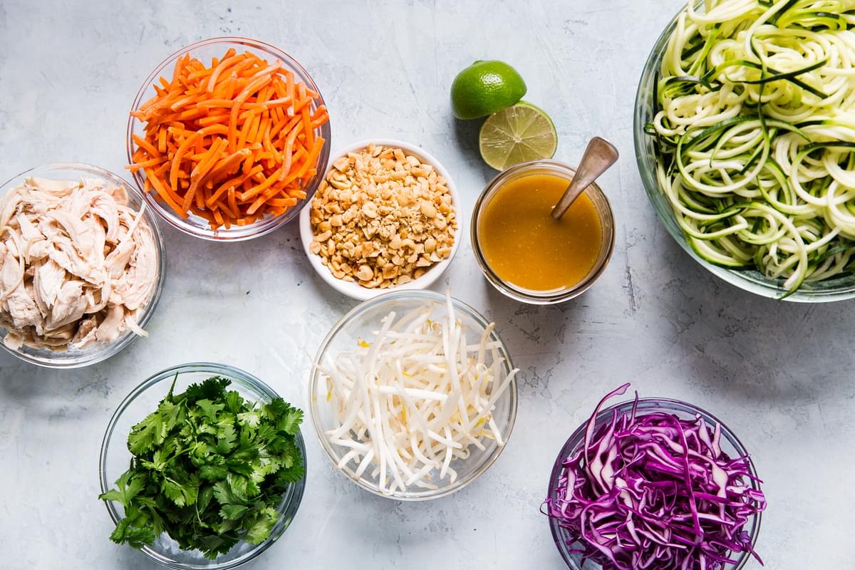 Ingredients for Thai zucchini noodle salad laid out in small bowls