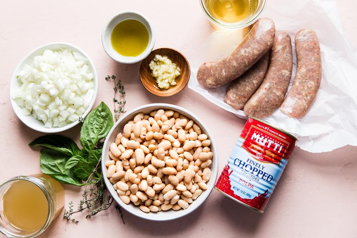 ingredients for tomato sausage Cassoulet white beans, white onions, basil, chicken broth, garlic