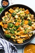 Tofu Stir-Fry with Peanut Sauce in a pan with a spoon
