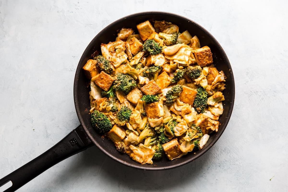 Tofu Stir Fry With Broccoli, Cabbage and peanut sauce in a pan