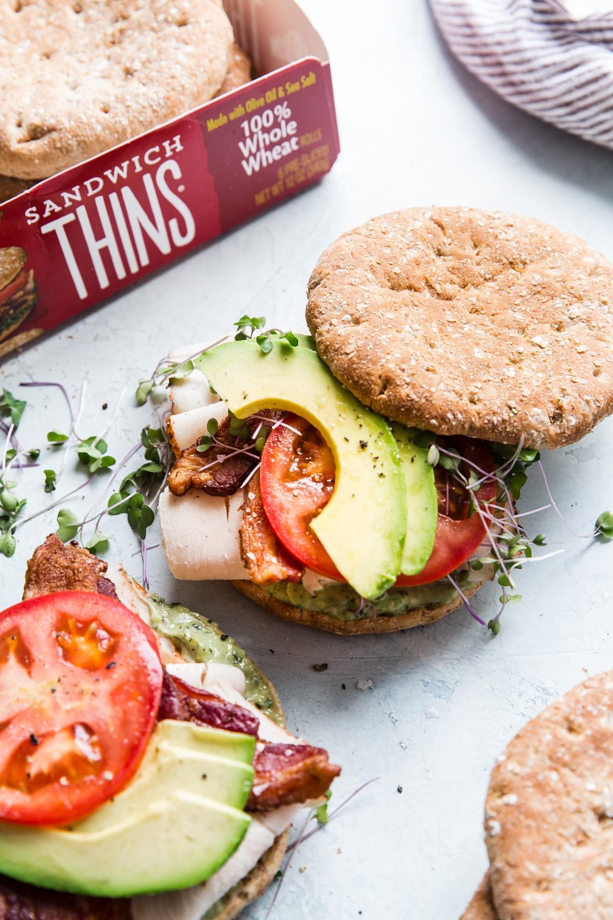Turkey Bacon Club Sandwich with avocado, tomato and sprouts on oroweat sandwich thins