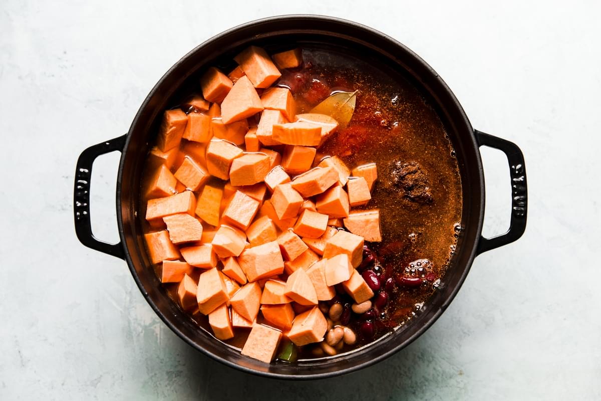 onion, pepper, sweet potatoes, beans, tomatoes, enchilada sauce, chili powder, cumin, bay leaves and salt in a large pot