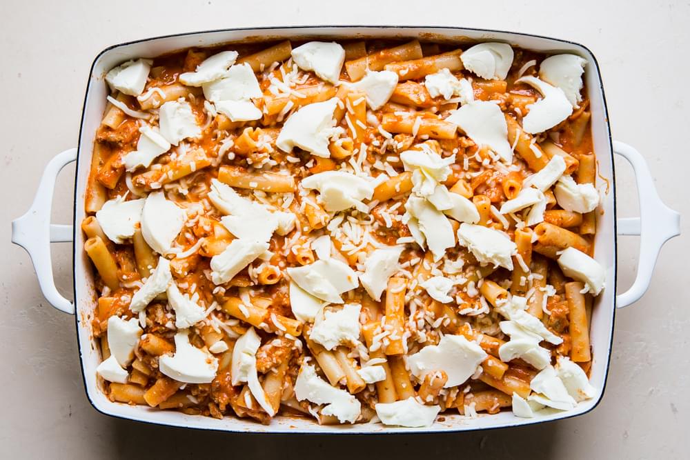 baked ziti in a casserole dish topped with mozzarella