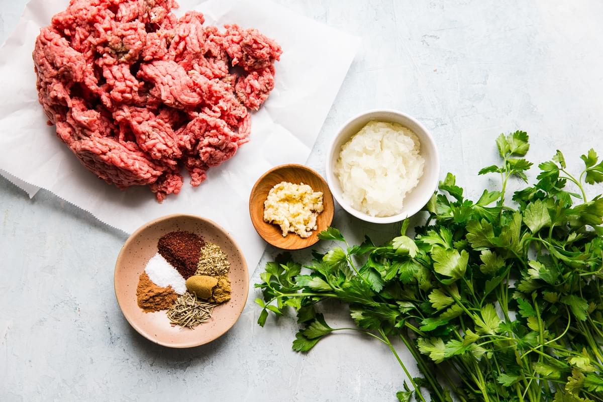 ingredients for beef kofta, ground beef, onion, garlic, spices and parsley