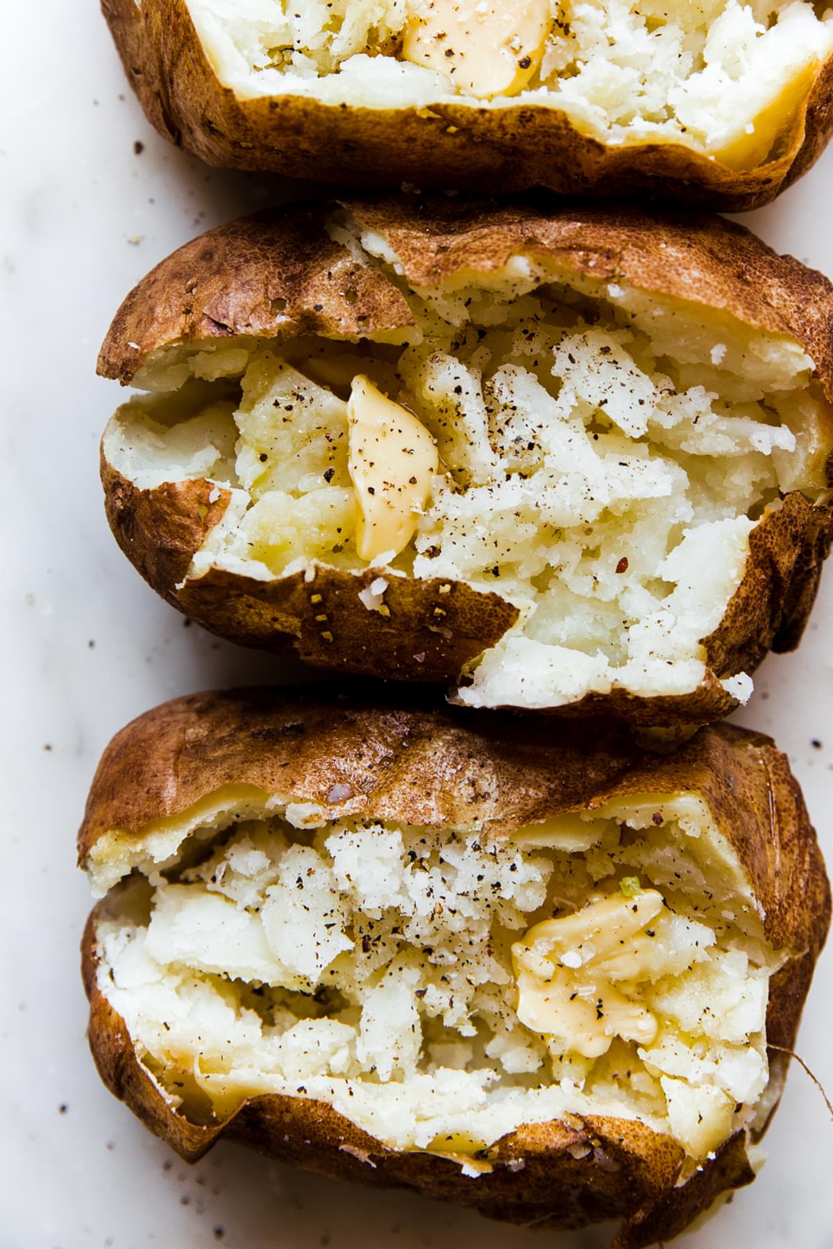 Easy baked potatoes with butter salt and pepper
