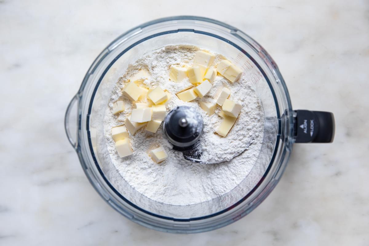 Flour and butter being pulsed in a food processor for making homemade buttermilk biscuits
