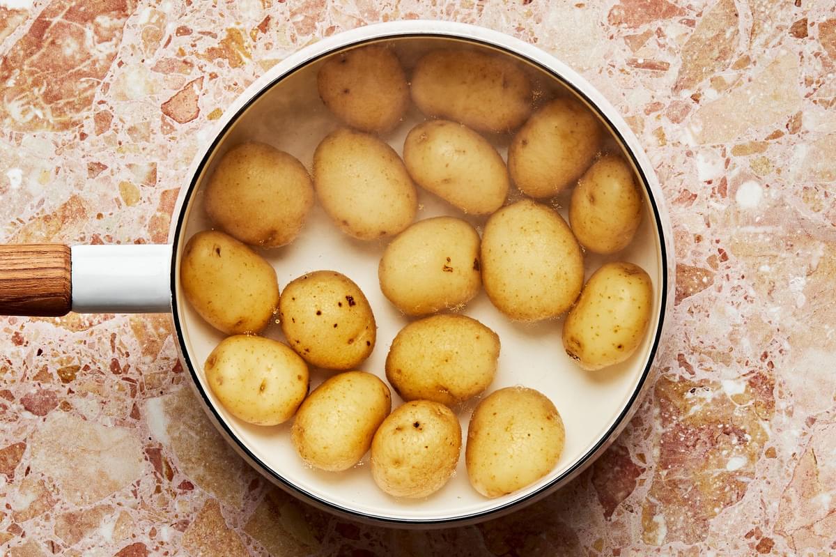sliced baby Yukon Gold potatoes boiled, in a pot