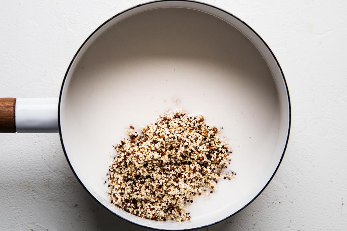 quinoa and coconut milk in a small pot for breakfast