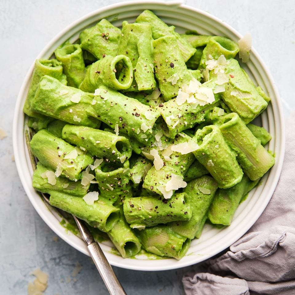 Rigatoni pasta with broccoli pesto in a bowl with a spoon