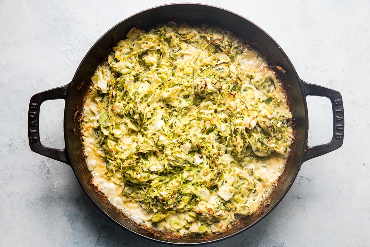 Brussels sprouts gratin with cream, garlic, Parmesan, Gruyere cheeses in a baking dish