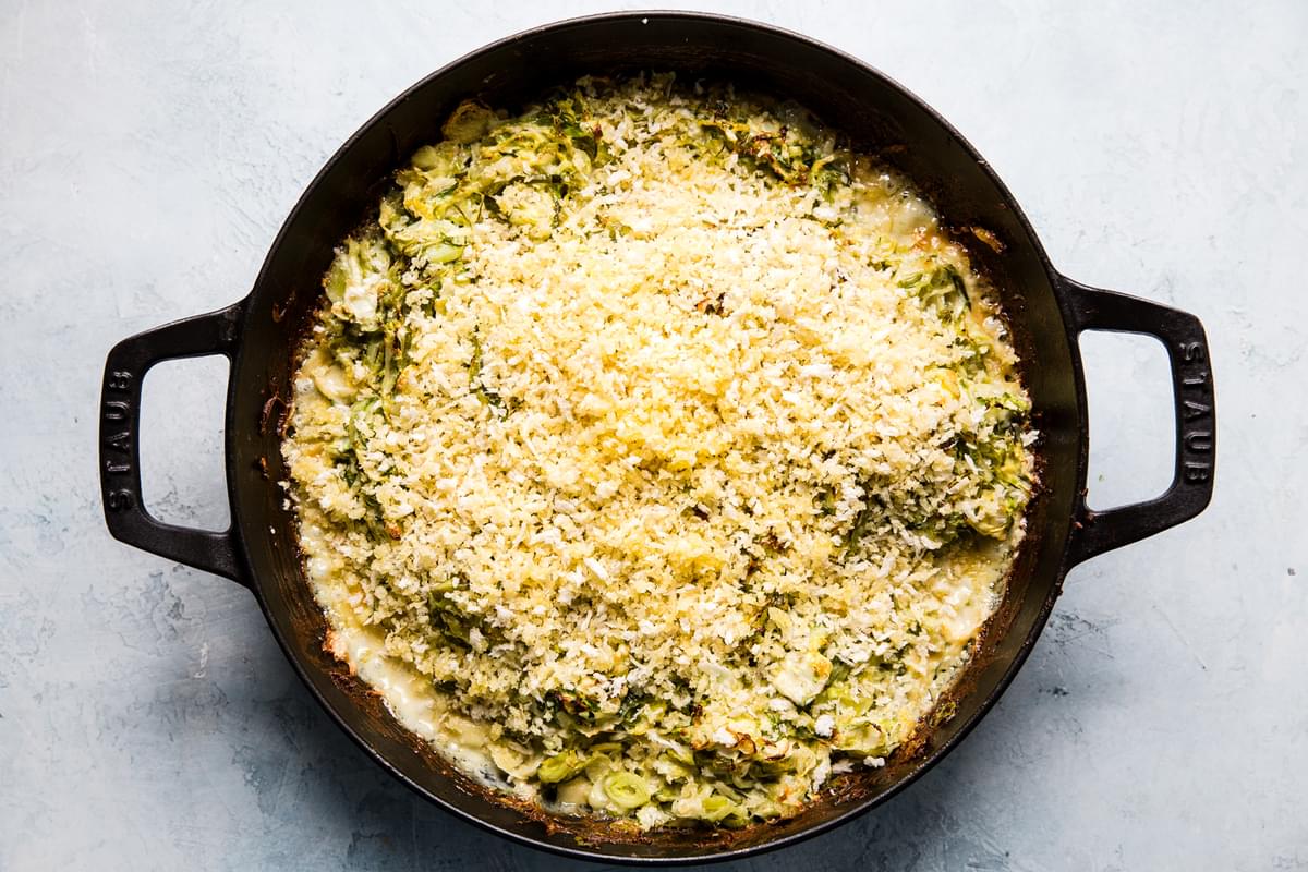 Brussels sprouts gratin with cream, garlic, Parmesan, Gruyere cheeses and bread crumbs in a baking dish