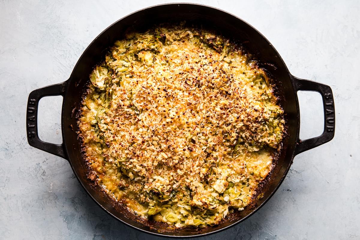 Brussels sprouts gratin with cream, garlic, Parmesan, Gruyere cheeses and toasted bread crumbs in a baking dish