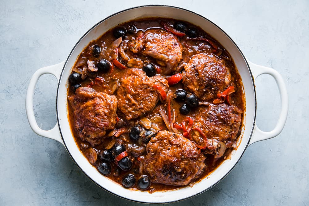 the best chicken cacciatore in a braiser with shallots, olives and bell peppers