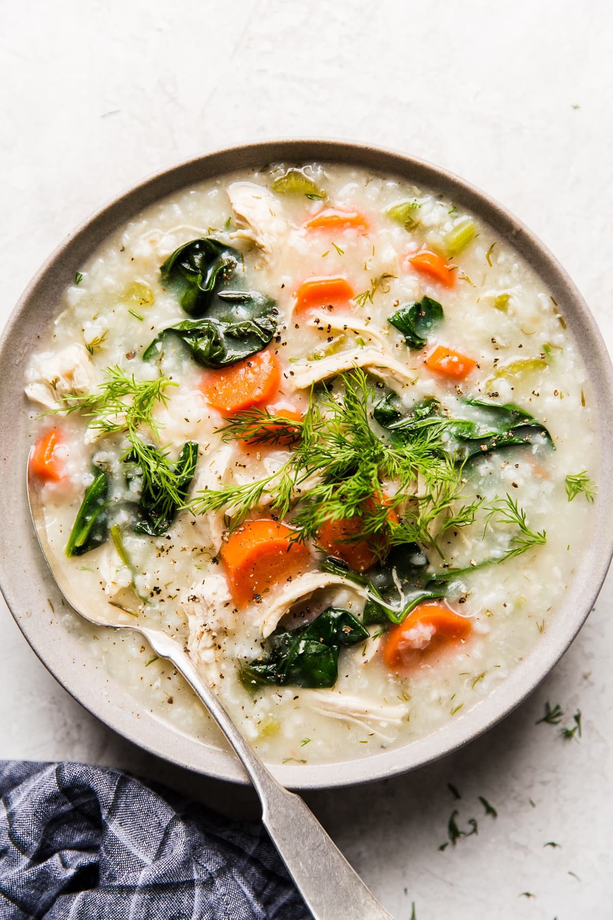 Chicken and rice soup with carrots, spinach, dill and lemon