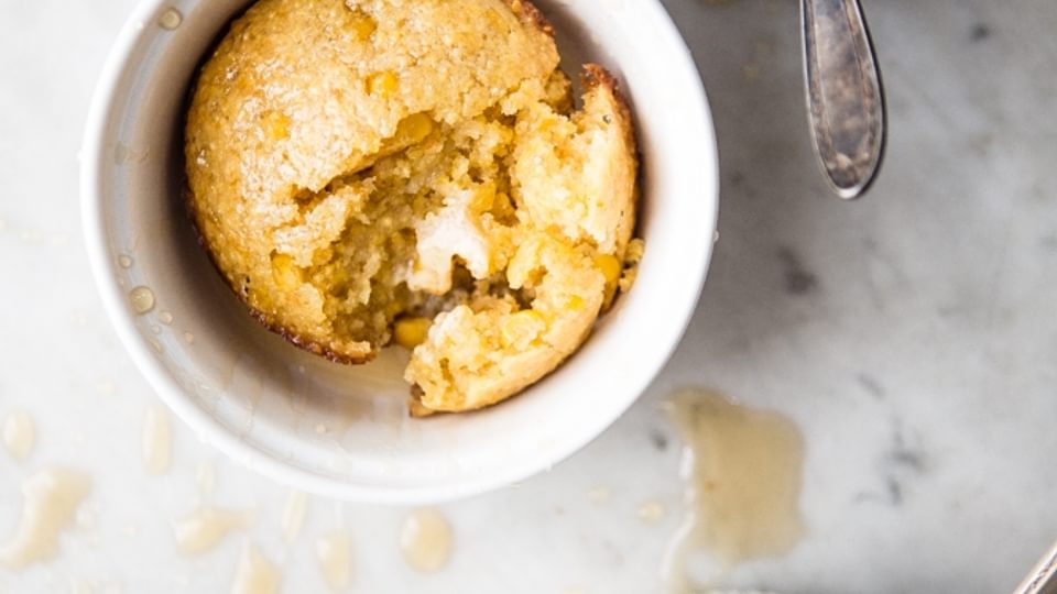 three corn bread muffins made creamed corn and jalapeño hone with butter