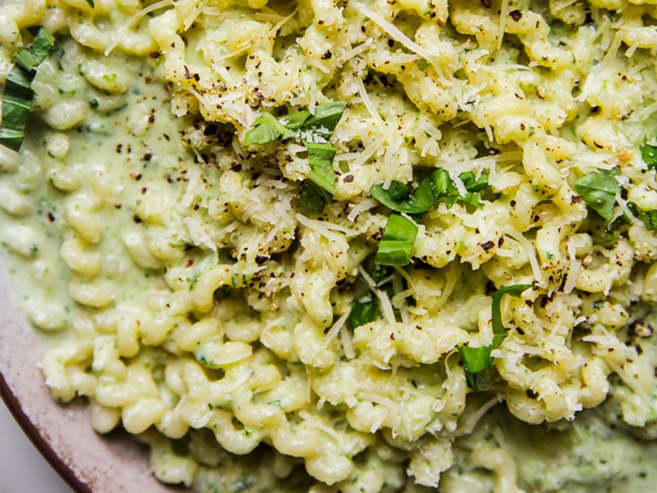 Creamy Zucchini Pasta Sauce with pasta in a bowl with basil.