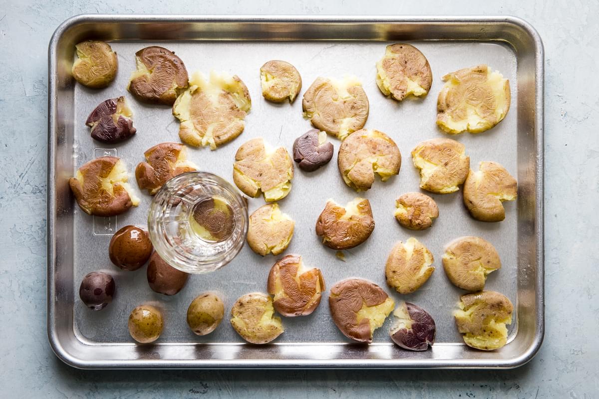 baby potatoes boiled and smashed on a baking sheet with kosher salt, olive oil and granulated garlic