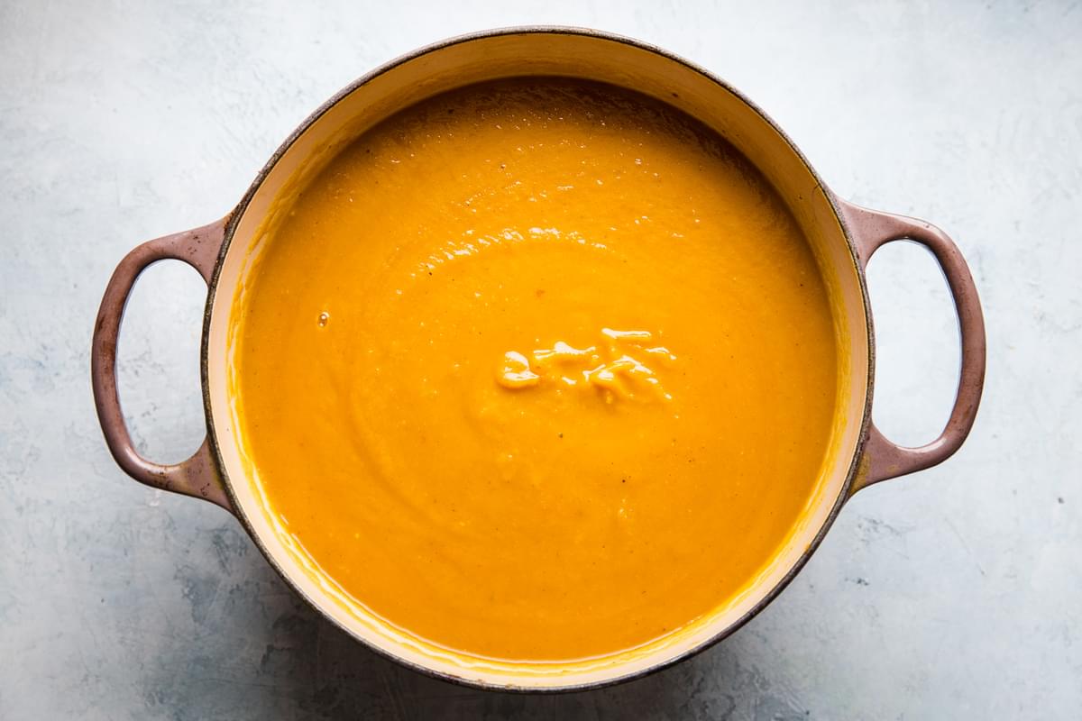 curried pumpkin soup blended in a soup pot