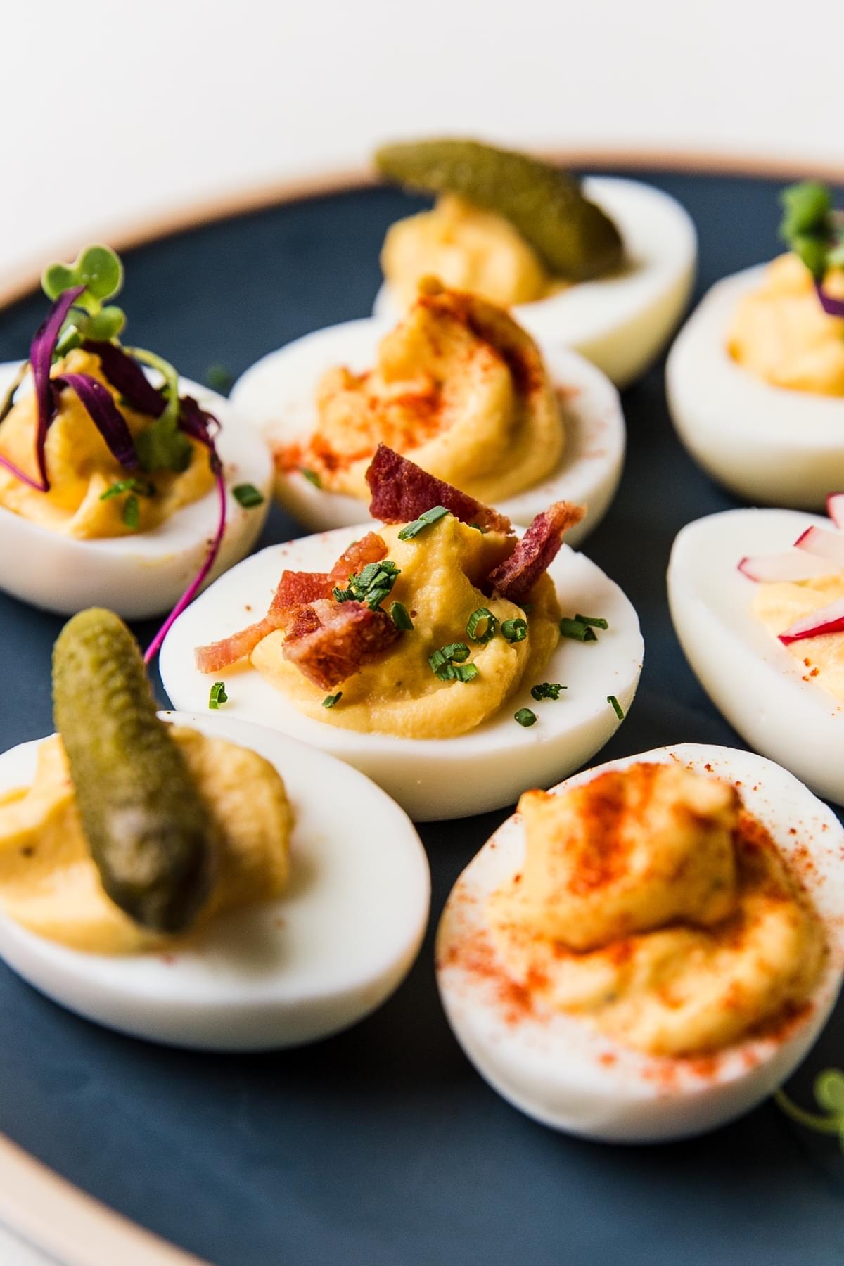 deviled eggs topped with pickles