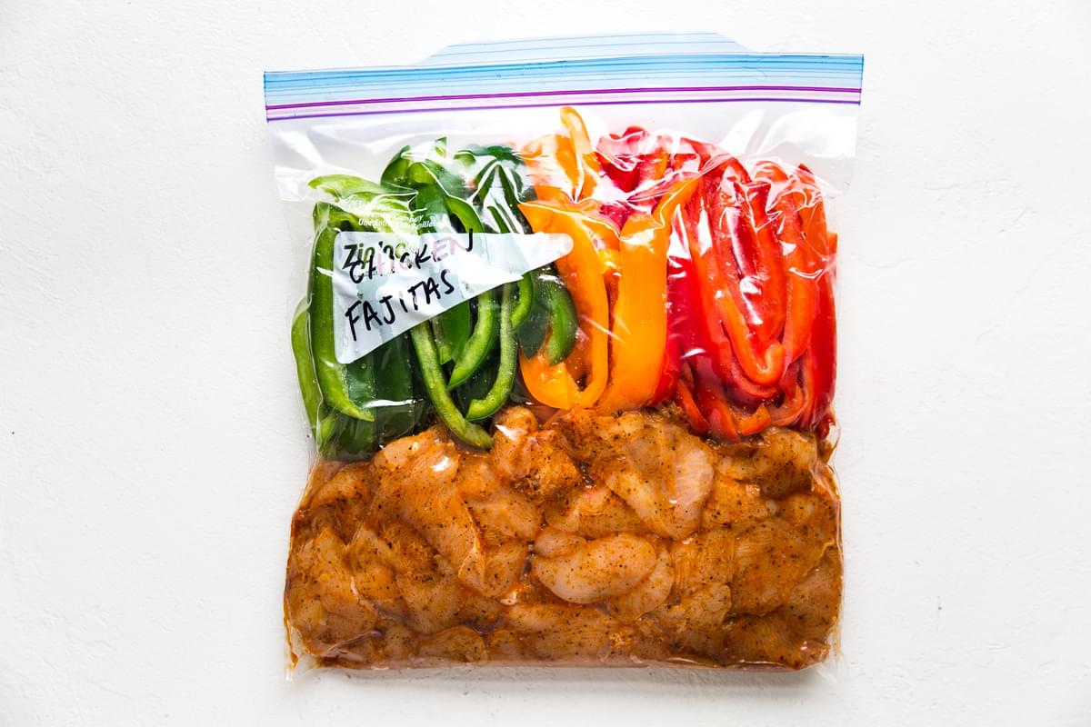 chicken fajitas dinner in a ziplock bag getting ready to be put in the freezer
