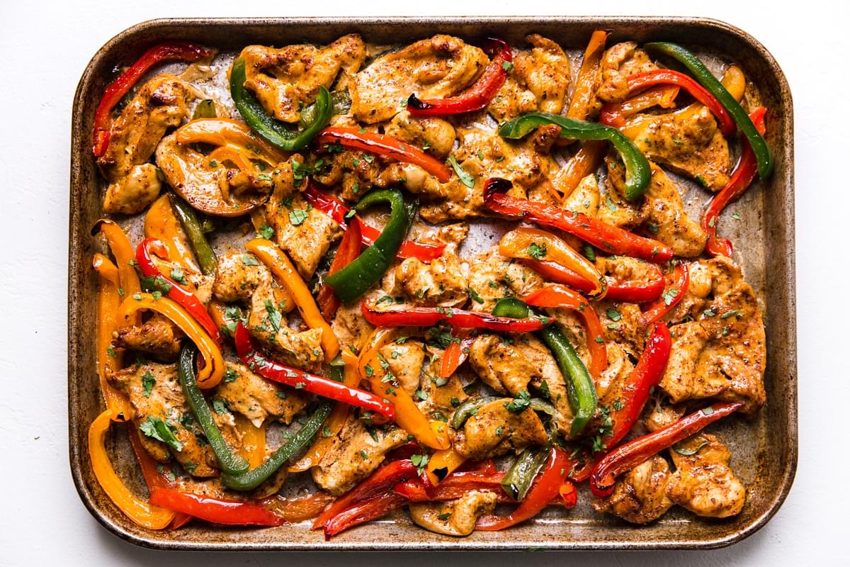 freezer chicken fajita meal on a sheet pan for dinner with tortillas bell peppers and onions