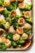 Freezer meal teriyaki chicken meatballs on a sheet pan with broccoli