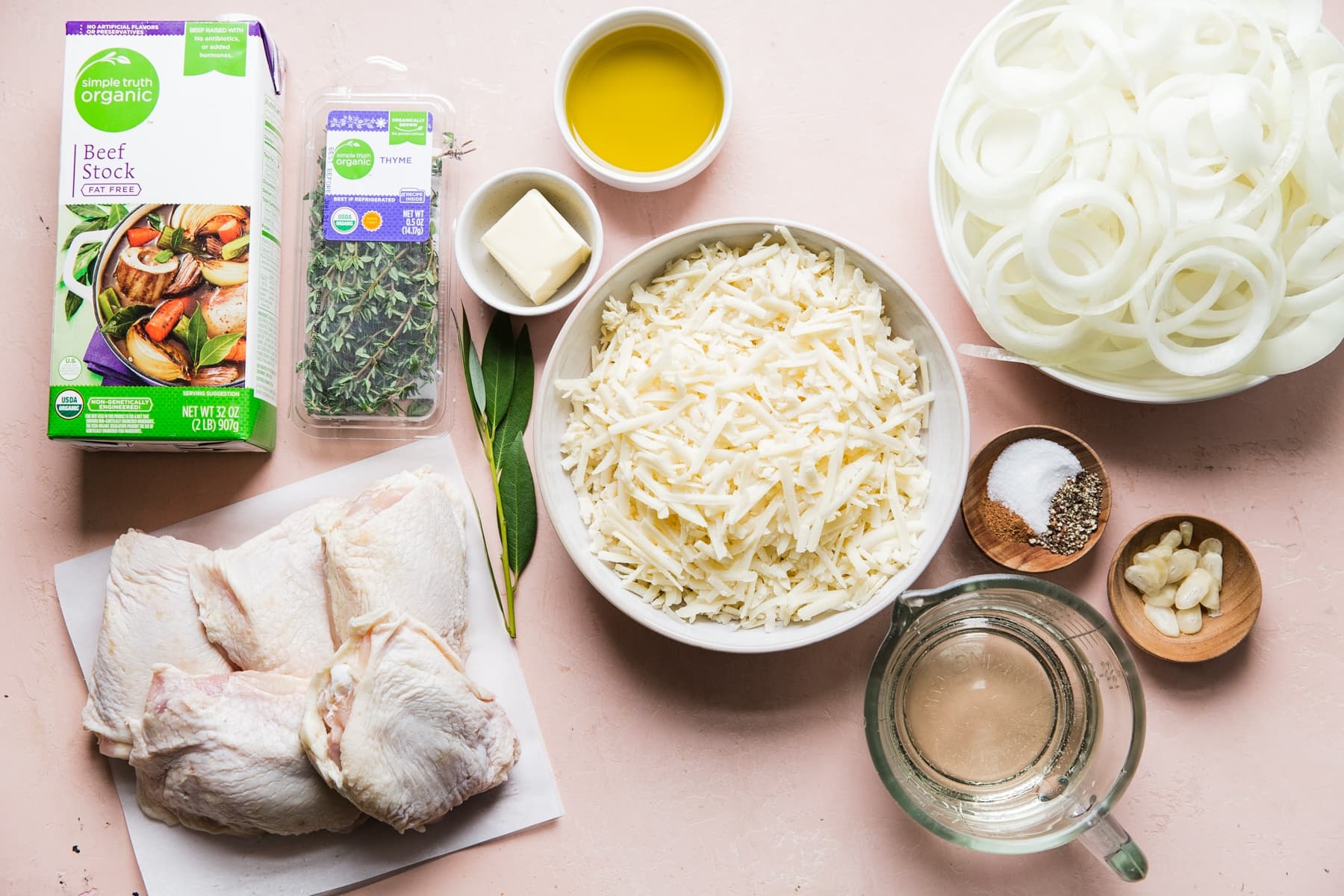 ingredients laid out for French Onion Chicken gruyere cheese, white wine, garlic, thyme and beef stock