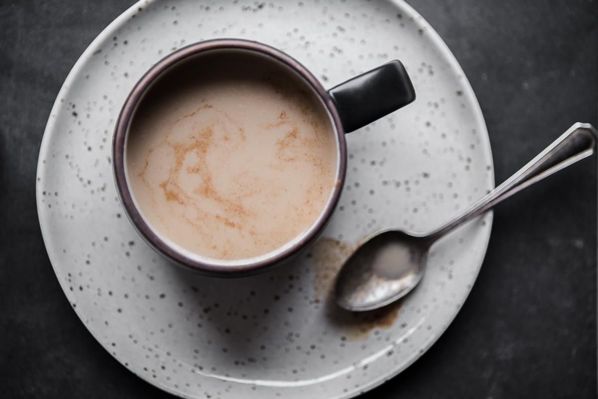A mug of Chai tea made with Homemade Chai tea concentrate with a spoon