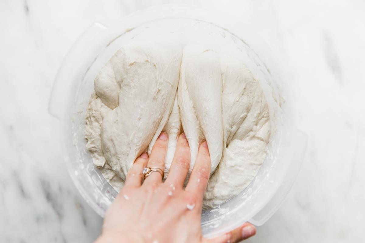 hand stretching and folding sourdough dough