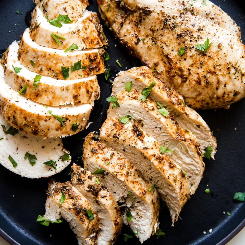 instant pot chicken that was cooked in the pressure cooker with seasoning on a black plate