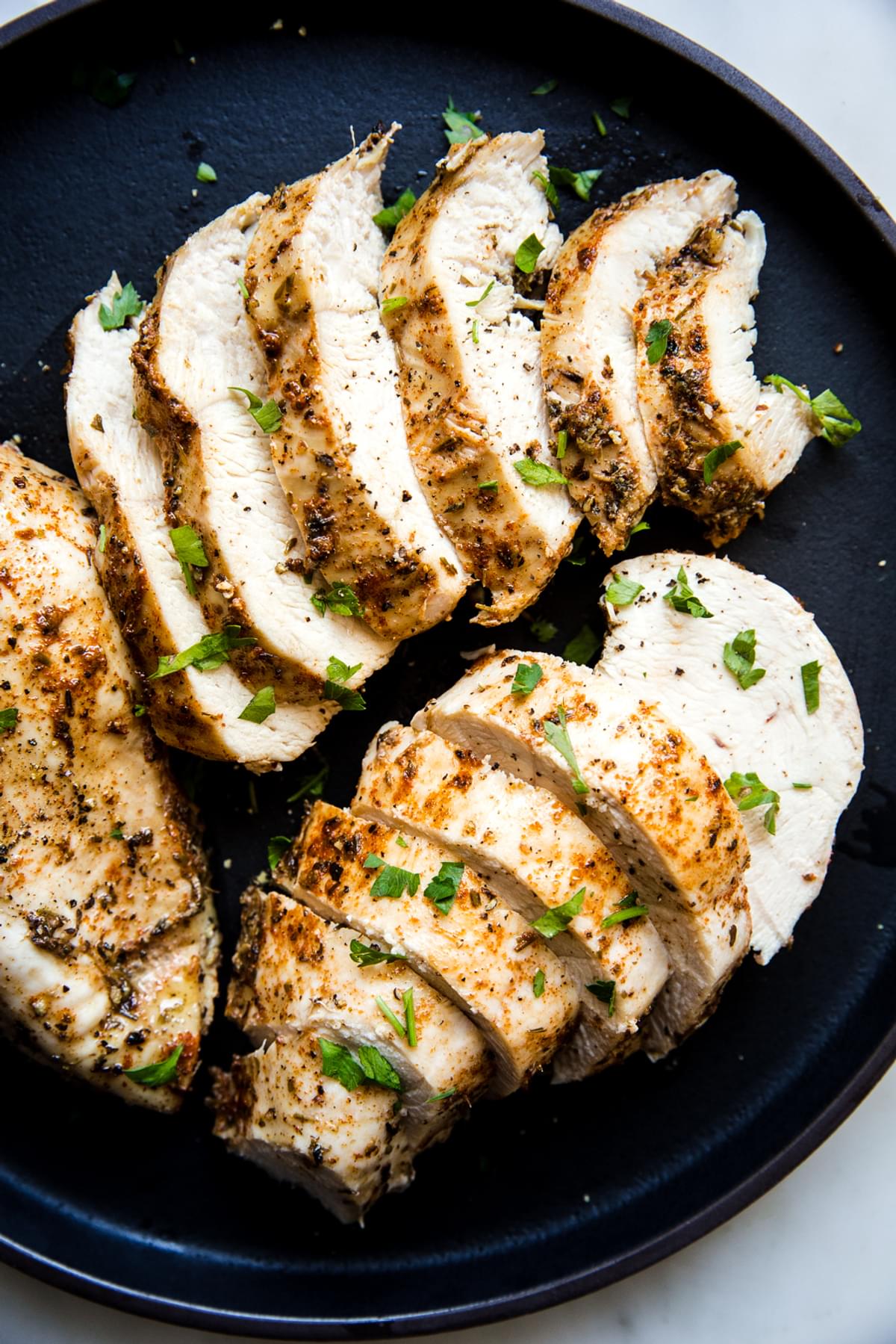 pressure cooker chicken that was cooked in the instant pot with seasoning on a black plate