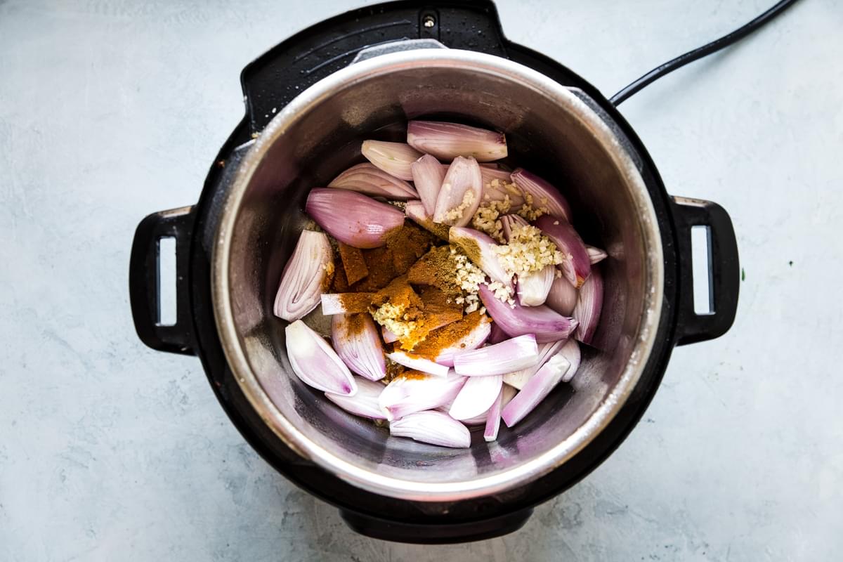 shallots, garlic and cinnamon browning in an instant pot