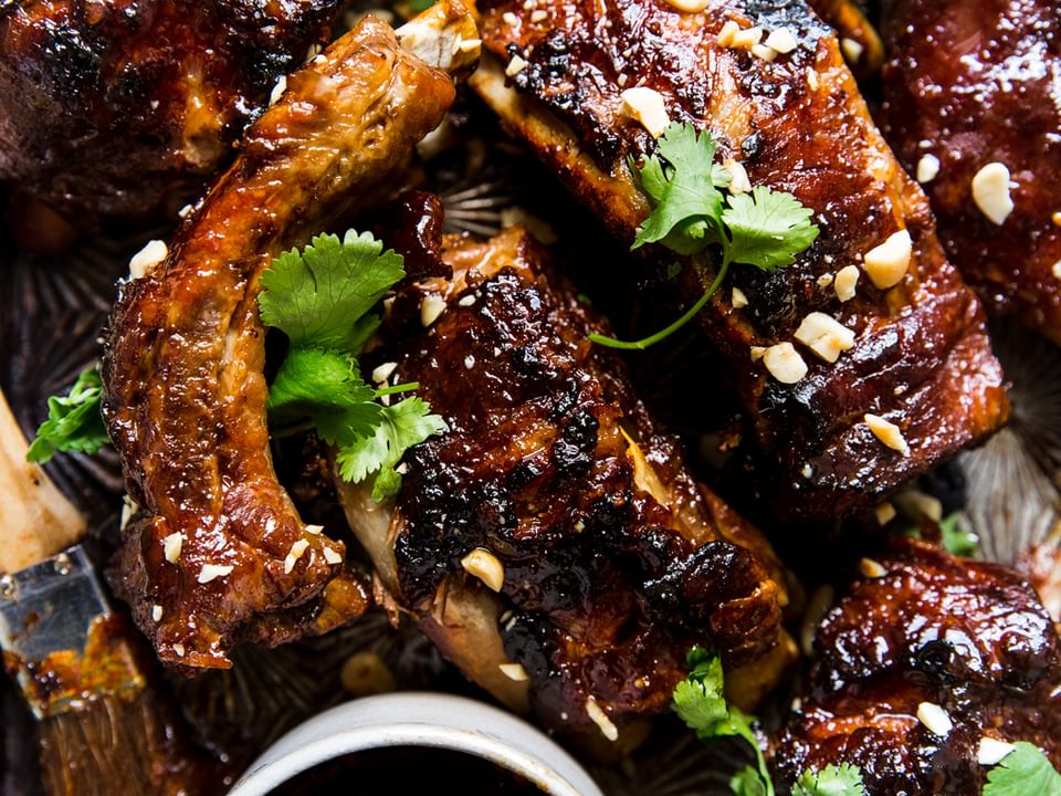 Instant pot baby back ribs with cilantro ginger, garlic, honey and lime sauce with peanuts