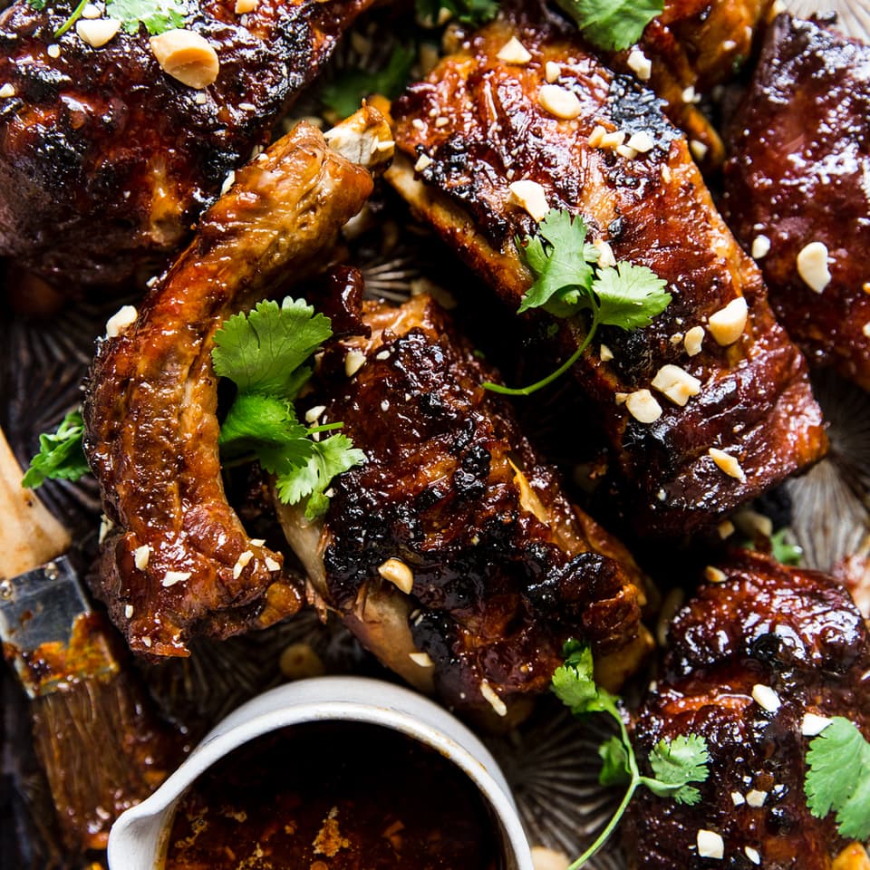 Instant pot baby back ribs with cilantro ginger, garlic, honey and lime sauce with peanuts