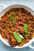 Mexican Brown Rice in a pan with avocado, and black beans