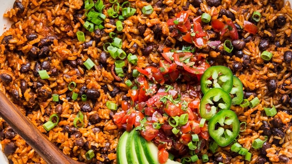 Mexican Brown Rice in a pan with avocado, and black beans