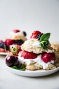 Mixed berry short cake with whipped cream on a plate