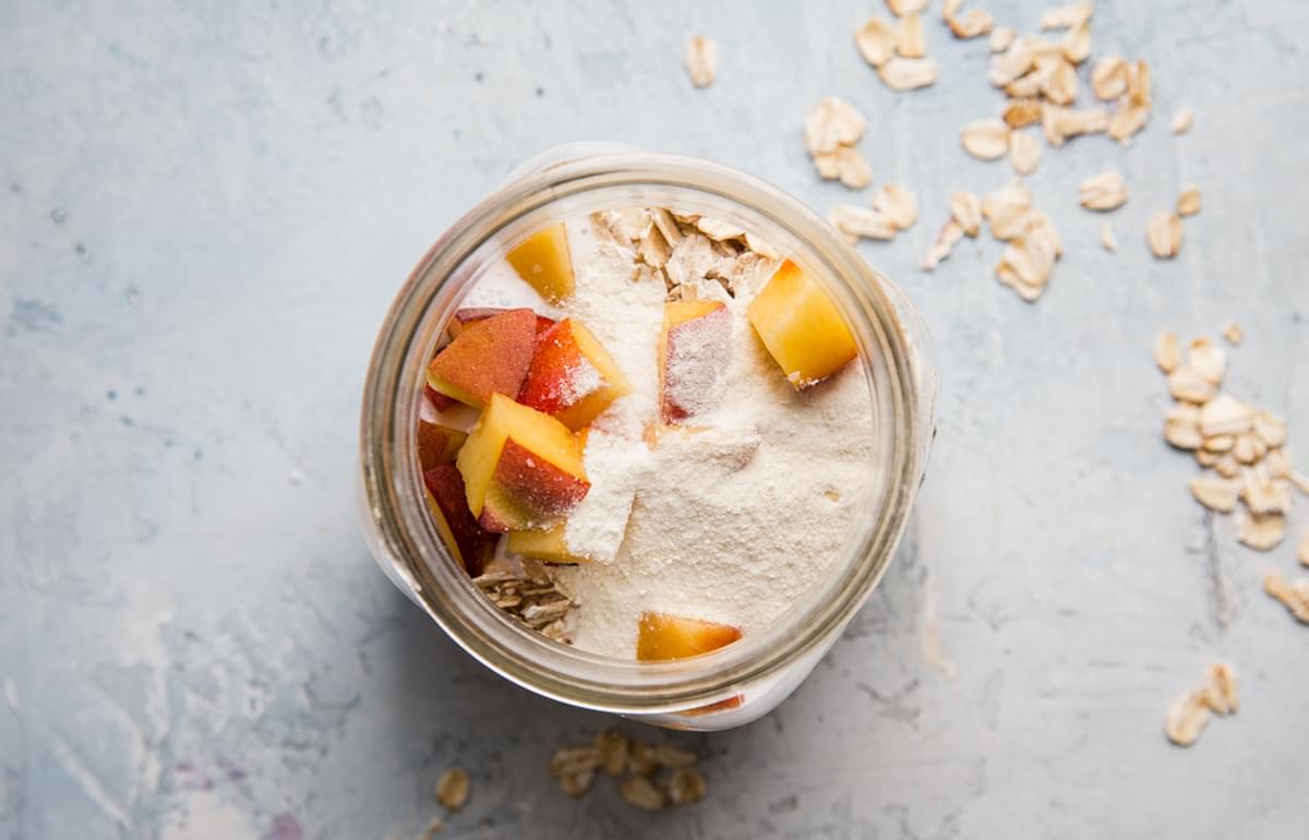 ingredients for peaches and cream overnight oats in a glass jar