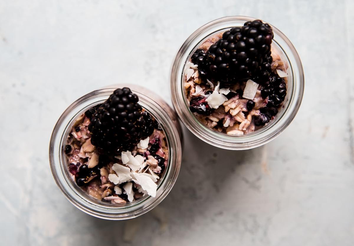 Overnight Oats in glass jars topped with blackberries